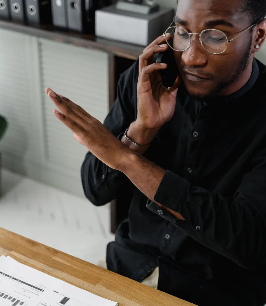 Accountant taking a phone call at an office desk