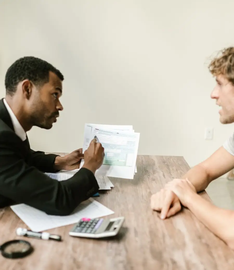 Accountant reviewing documents with a client across a desk