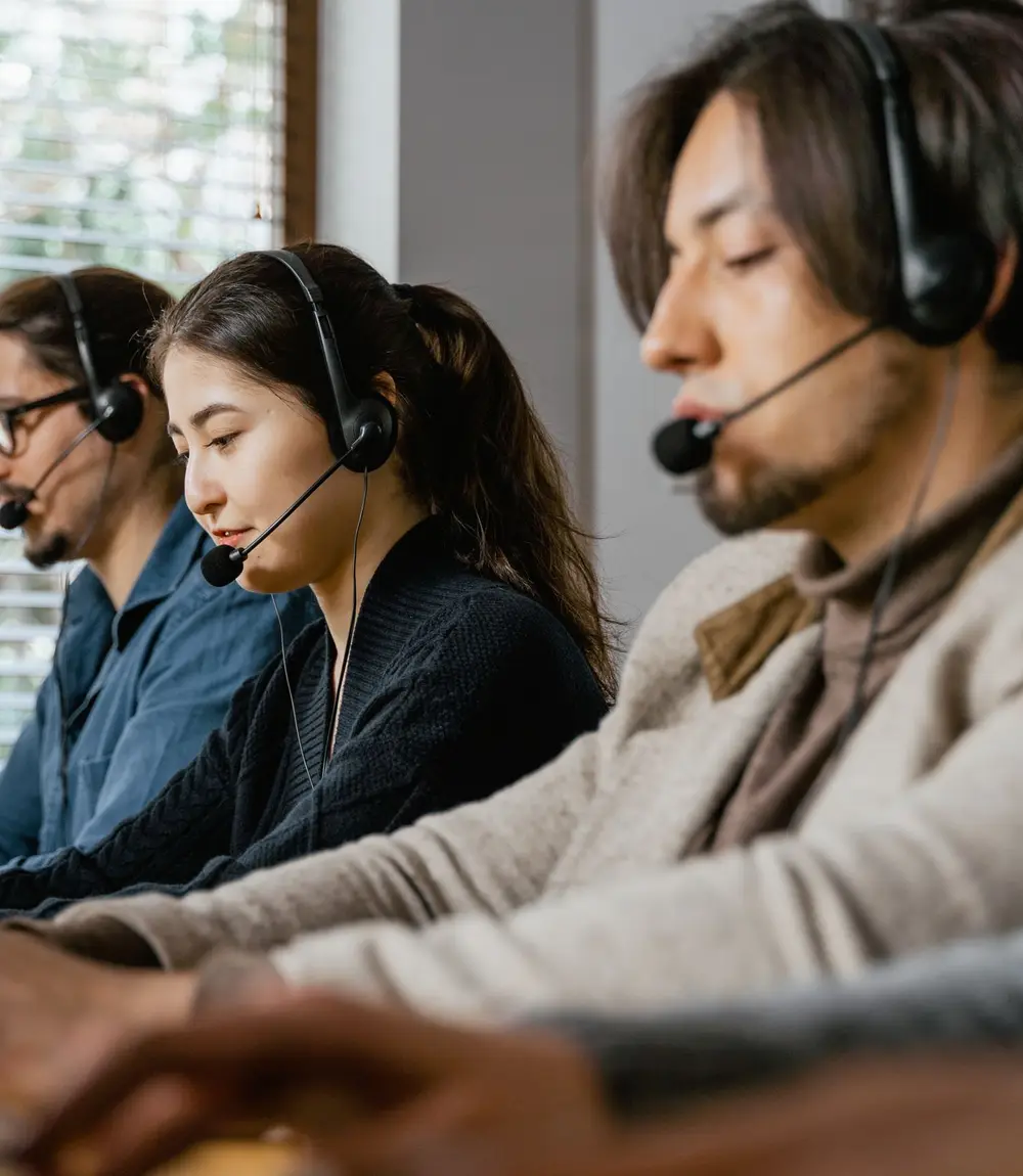 Row of agents taking calls on headsets