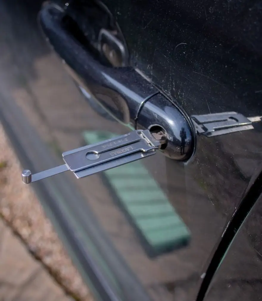 Lock pick tool inserted into the lock of a car door
