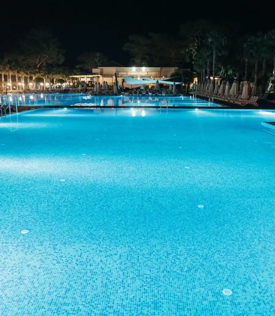 Resort swimming pool lit up at night