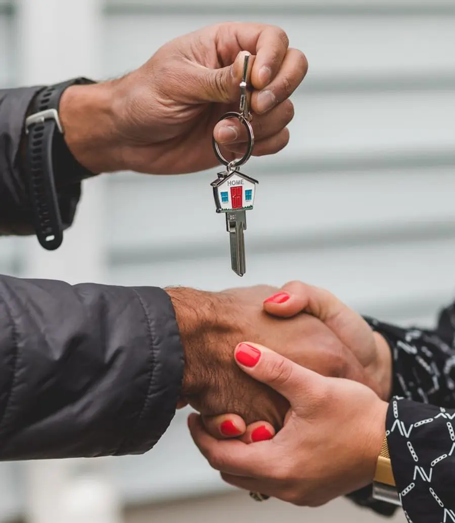 House keys being handed over with a handshake