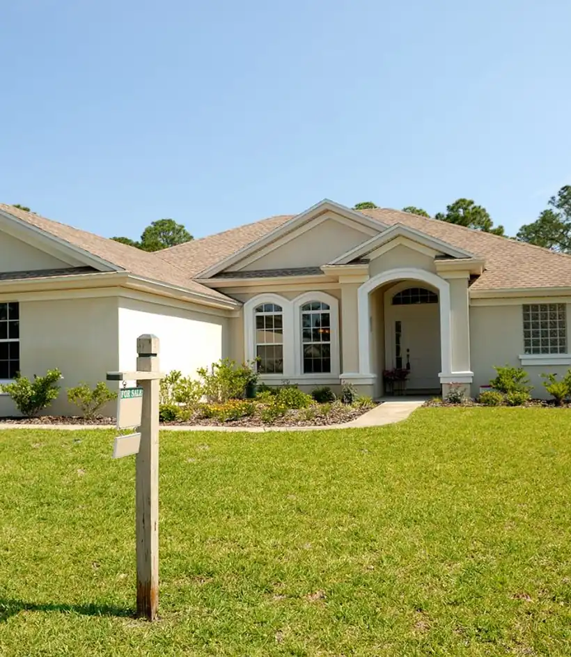 Single-family home with a for-sale sign in the front yard