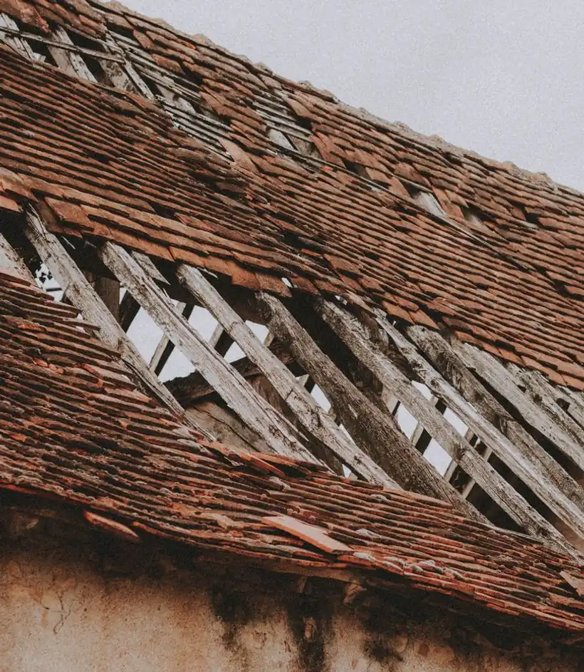 Storm-damaged roof with missing tiles exposing the battens beneath