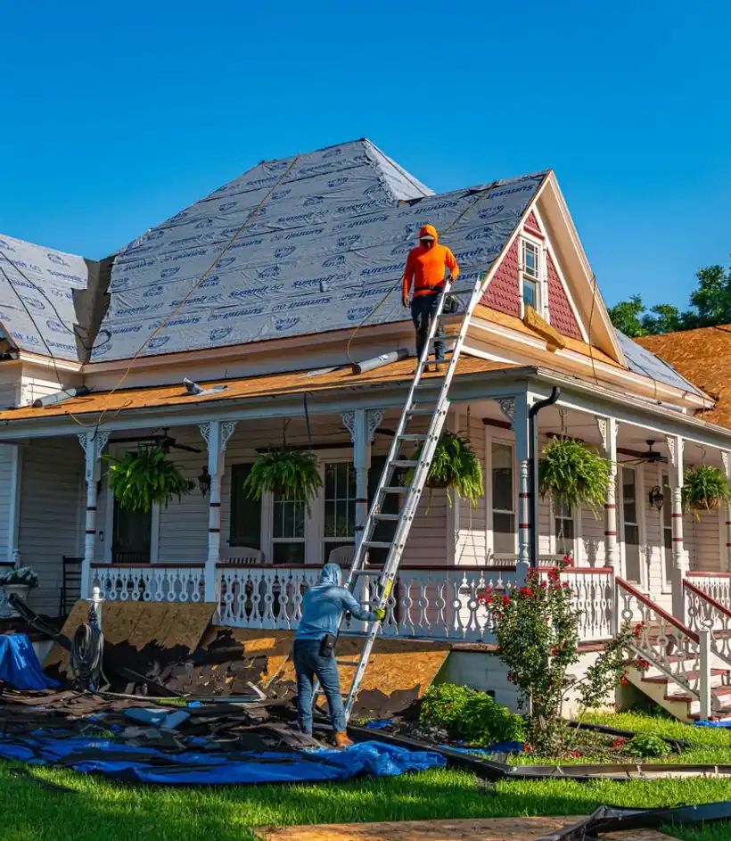 Full-house re-roof project with a crew and tear-off in progress
