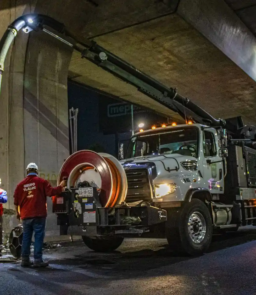 Vacuum truck working a street job at night