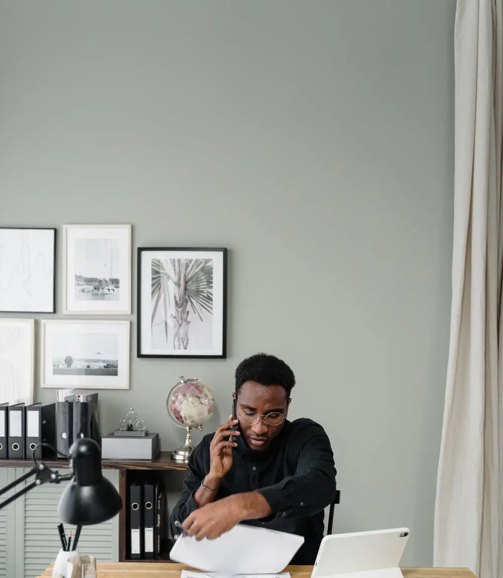 Accountant taking a client call at a desk in a modern office