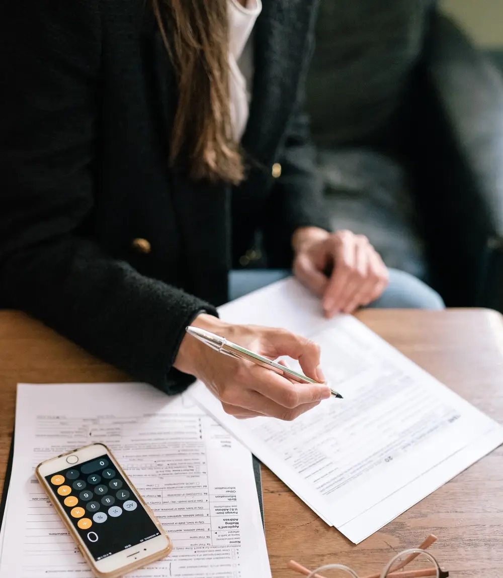 Accountant reviewing financial documents with a calculator