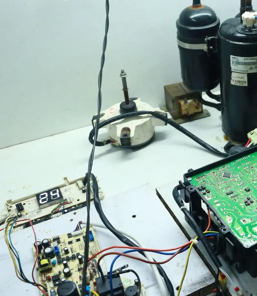 Technician testing an appliance control board with a multimeter