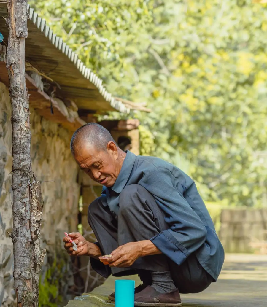 Contractor repairing a wooden fence with hand tools