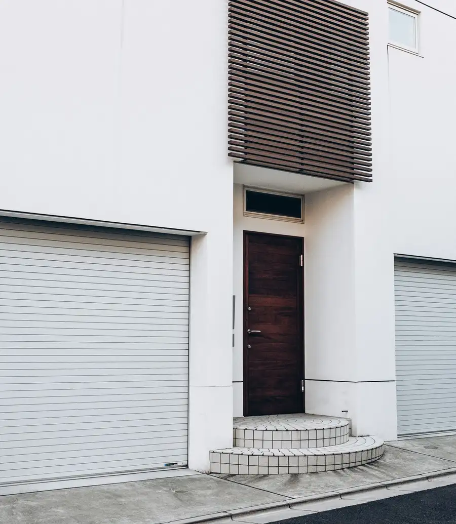 Modern house facade with two roll-up garage doors