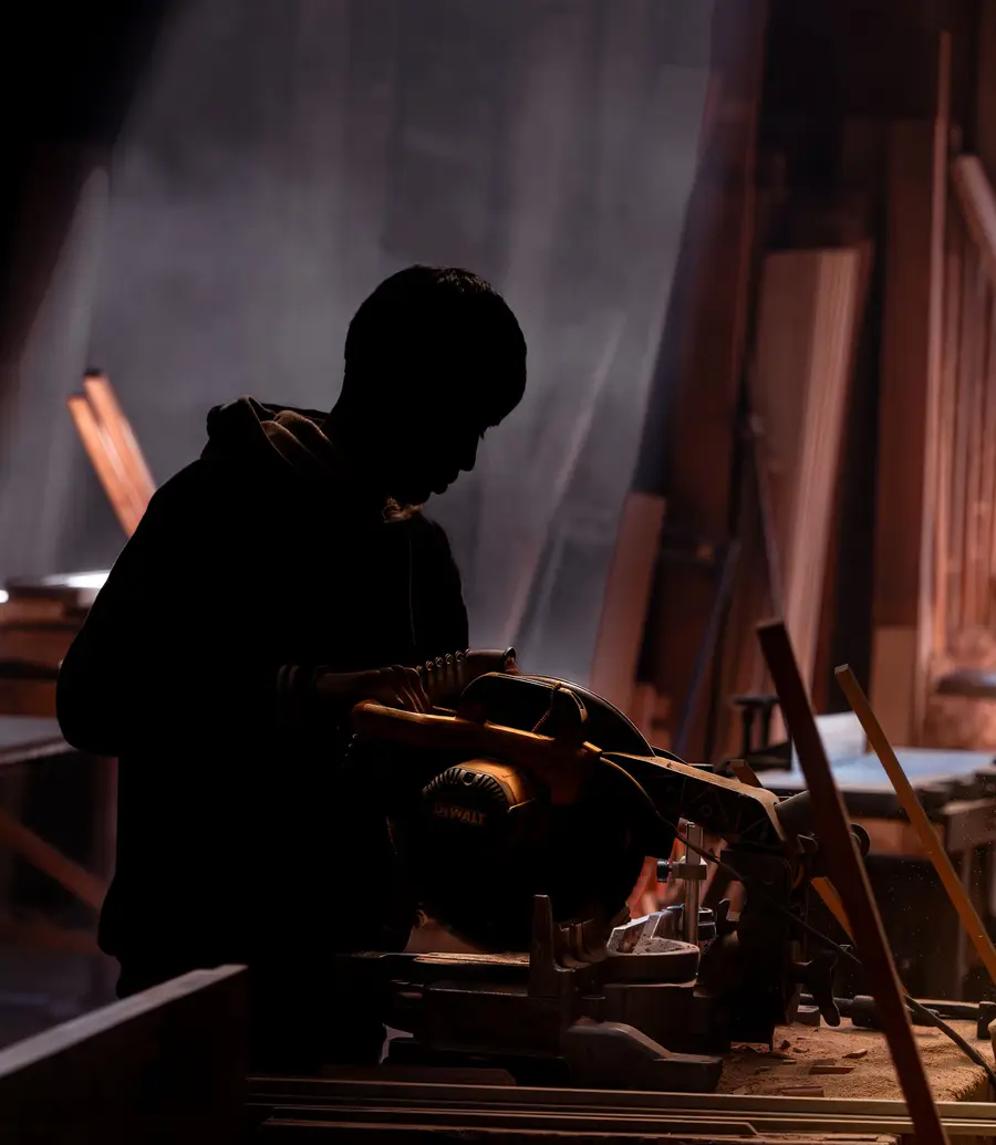 Handyman using a power tool in low evening light