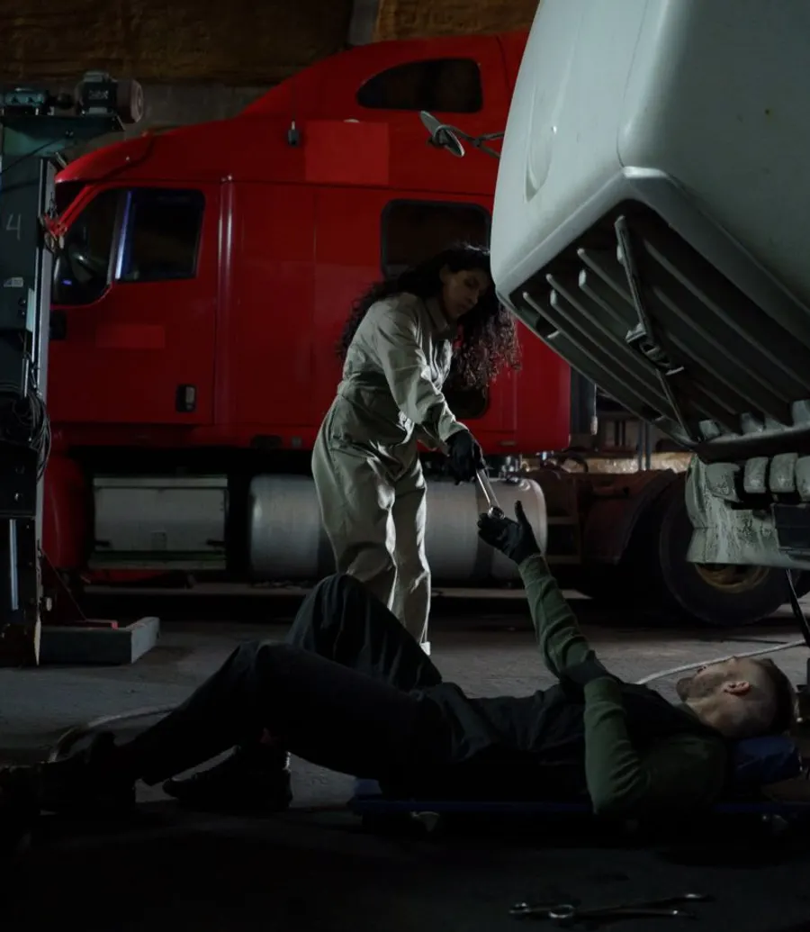 Mechanic working on a vehicle in low evening light