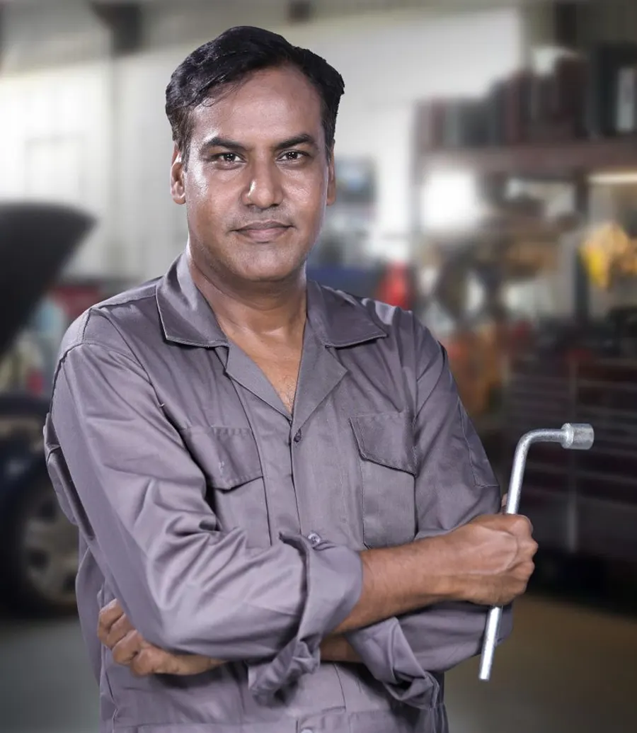 Mechanic holding a wrench in an auto repair shop