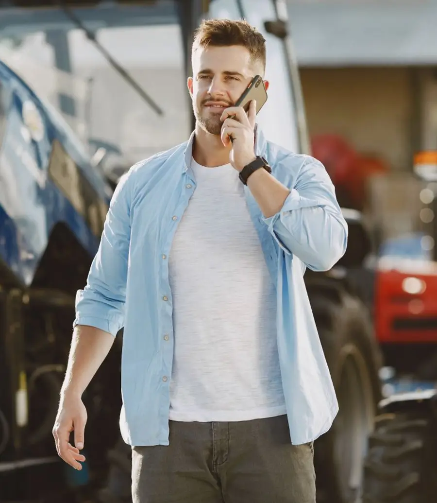 Mobile veterinarian taking a call beside a practice vehicle