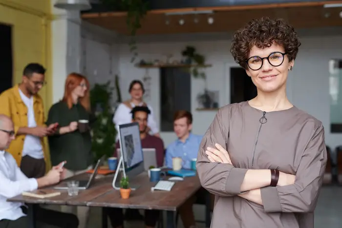 A consultant standing confidently in front of their team