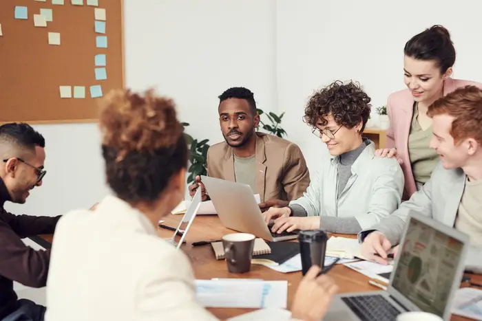 A large group meeting around a table