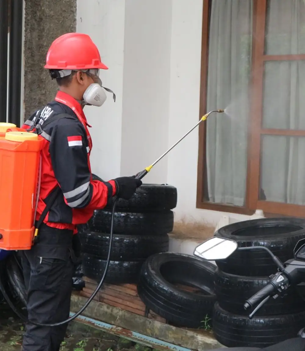 Wildlife-control technician working at the exterior of a home