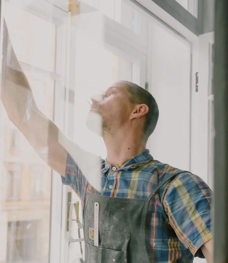 Glazier assembling a window with the glass pane in view