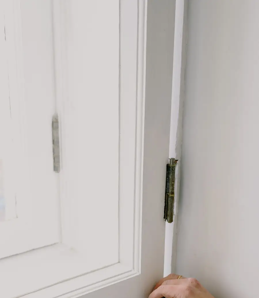 Installer measuring a window opening on the sill during a fit